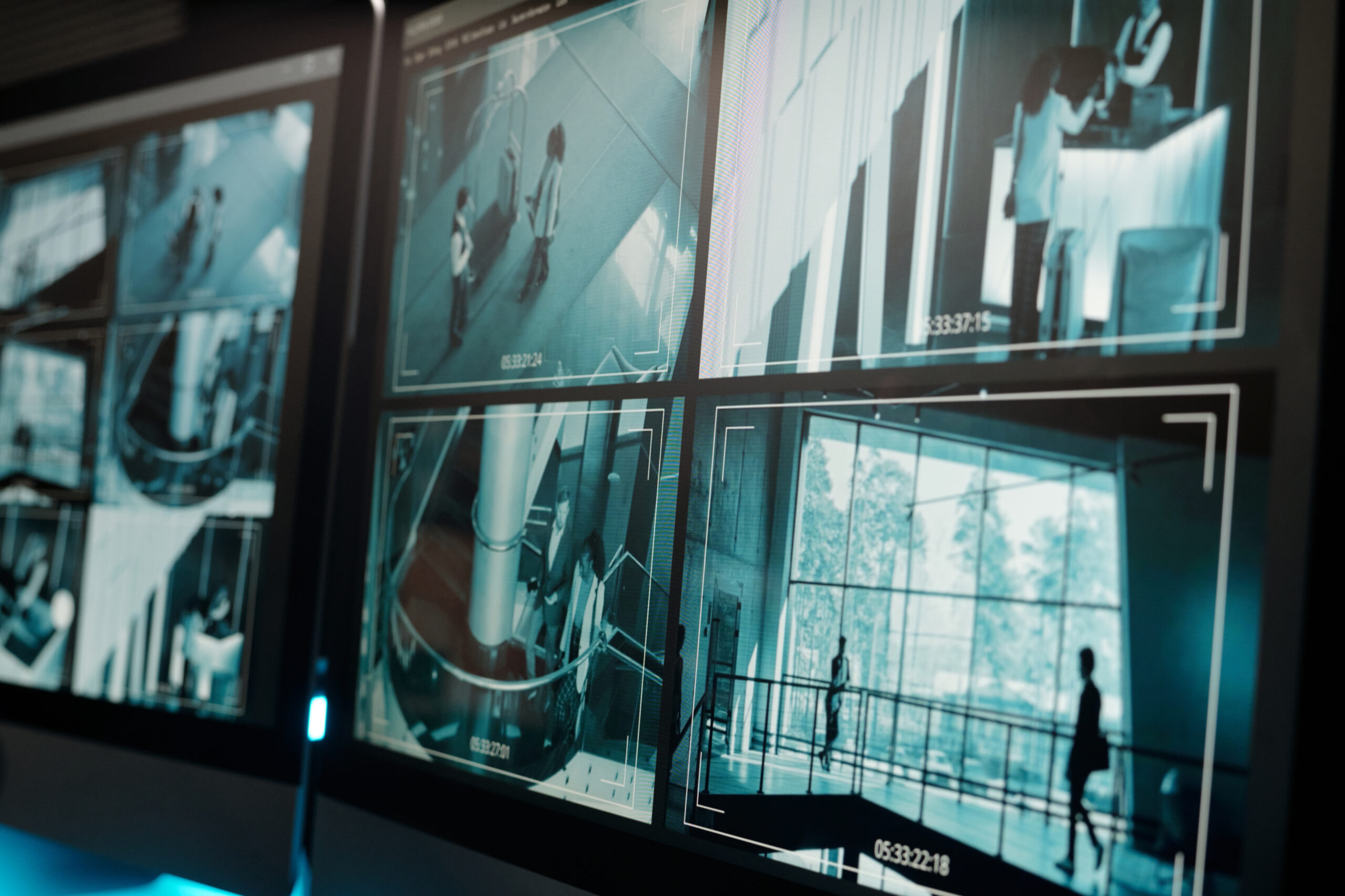 Screen of desktop computer with cctv video system standing on workplace of security guard or officer of surveillance room